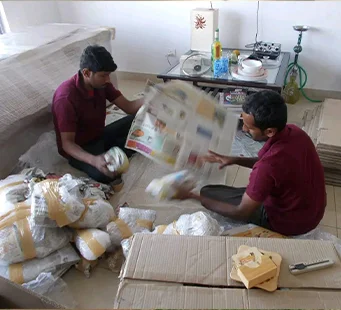 Crew carefully packing kitchen items and crockery